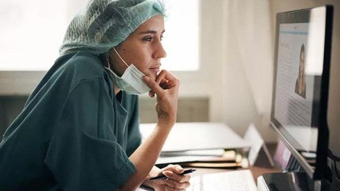 Doctor reviewing patient notes Doctor reviewing patient notes