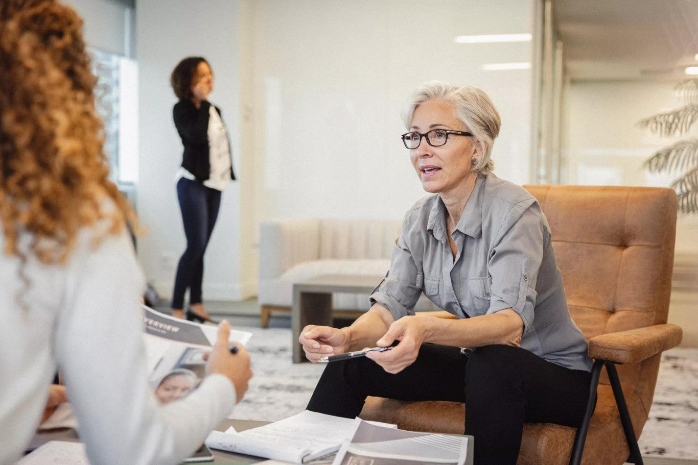 A female not-for-profit board trustee holding a pen and discussing investment services options for their nonprofit organization’ A female not-for-profit board trustee holding a pen and discussing investment services options for their nonprofit organization’