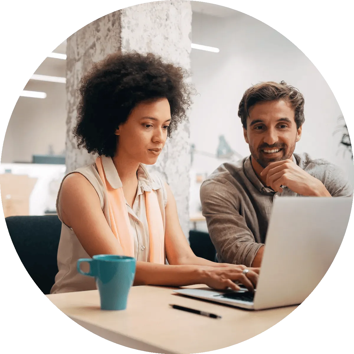 A man and woman looking at a computer together.