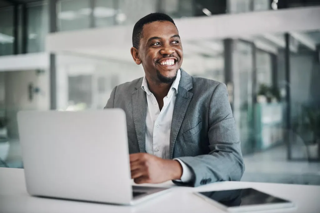 A business professional smiling in an office setting.