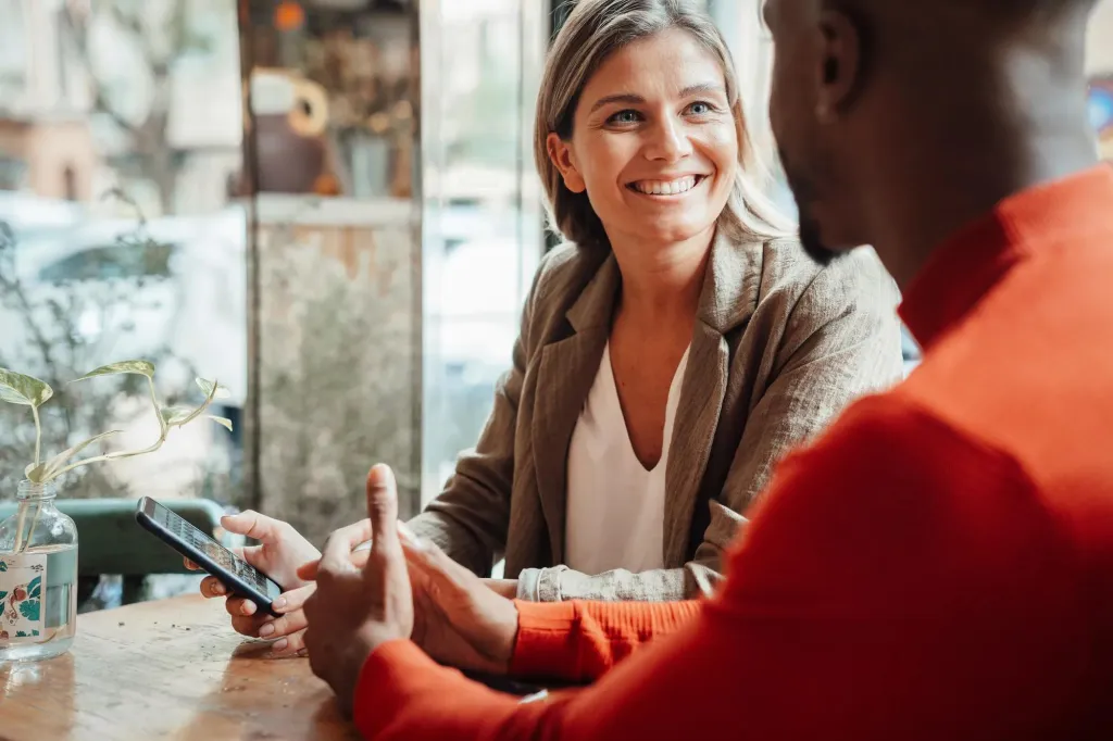 Colleagues talking in a conference room. 