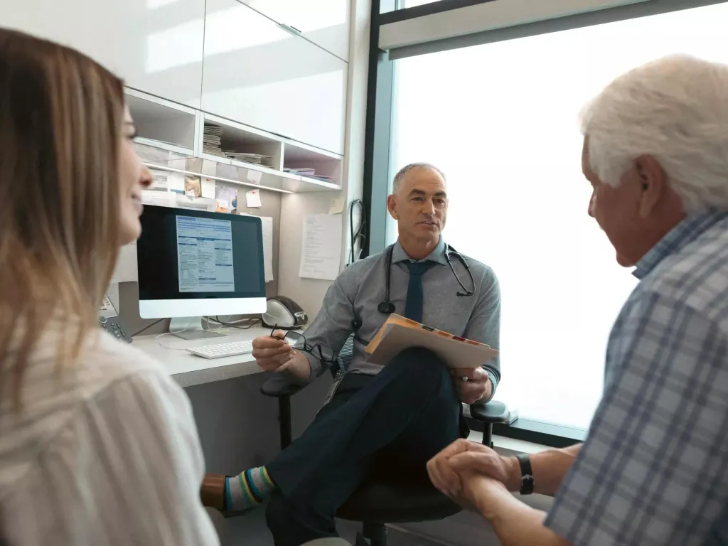 Doctor talking to his patient about his critical illness.