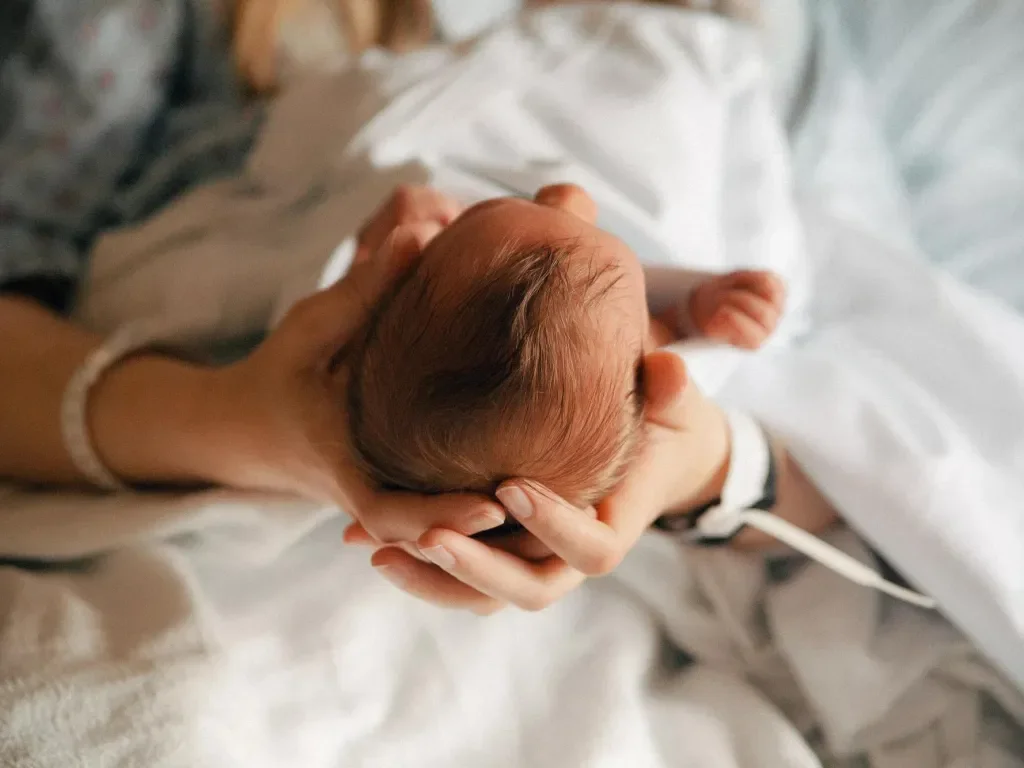A mother holding her newborn baby.