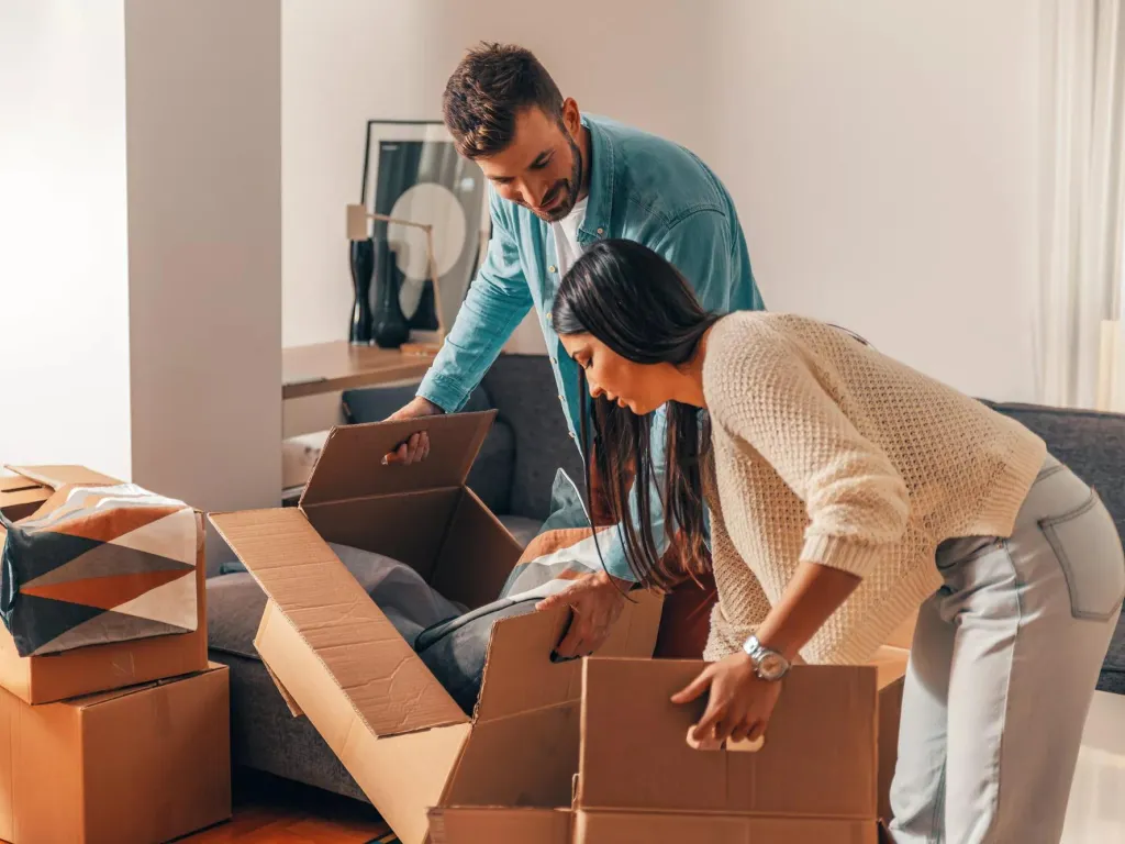 Two people moving boxes.