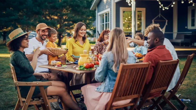 A family eating in their backyard.