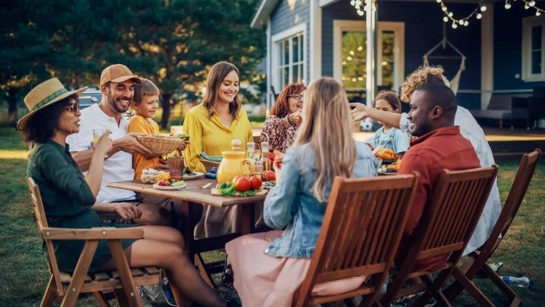 A family eating in their backyard.
