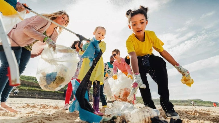 Adults and kids volunteering outside