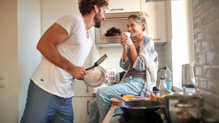 Young man and woman in kitchen.