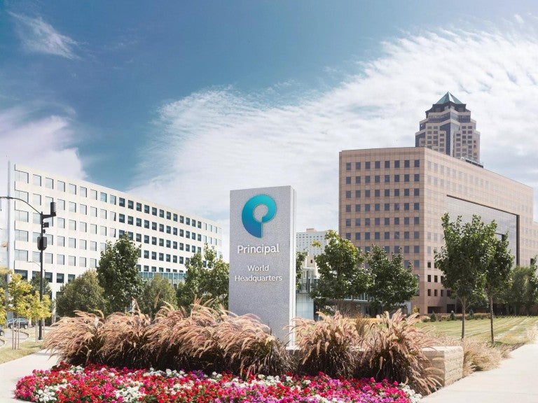 Principal campus signage with notable Des Moines buildings in the background