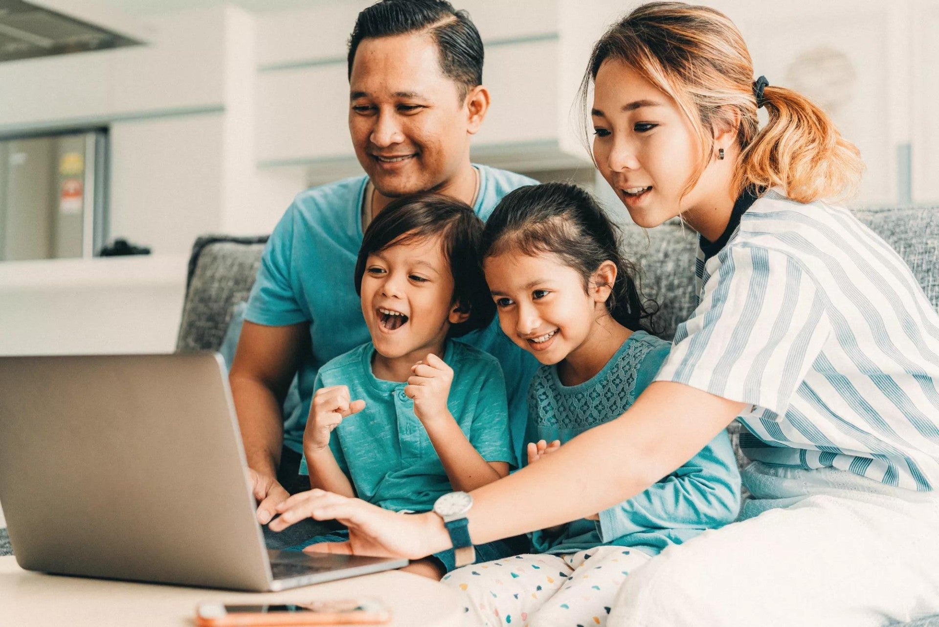Happy family using laptop together. Happy family using laptop together.