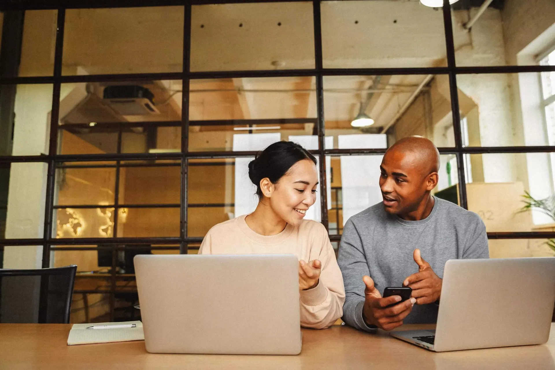 Man and a woman conversing in an office.
