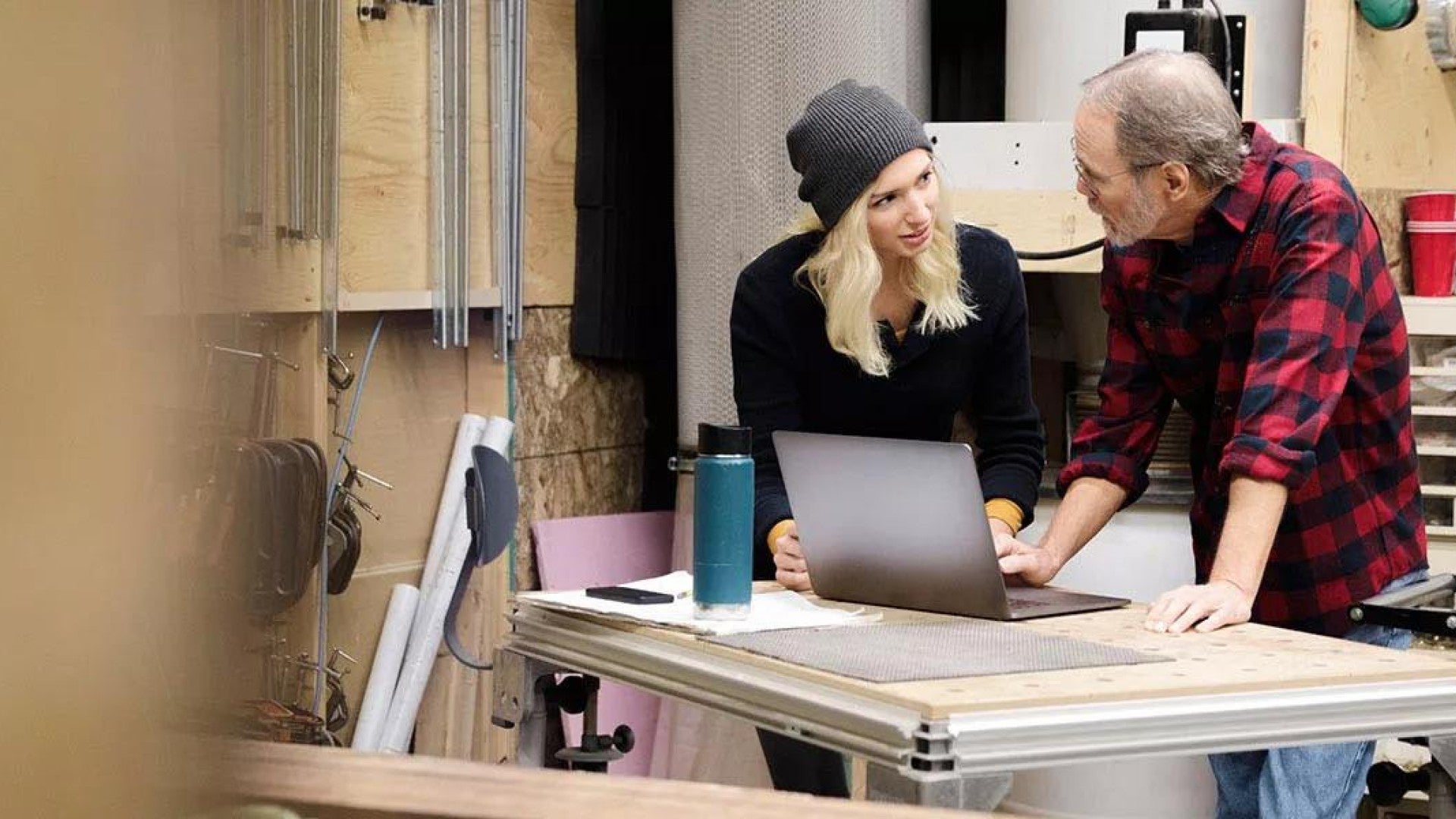 Photo of a father and daughter working in a workshop.