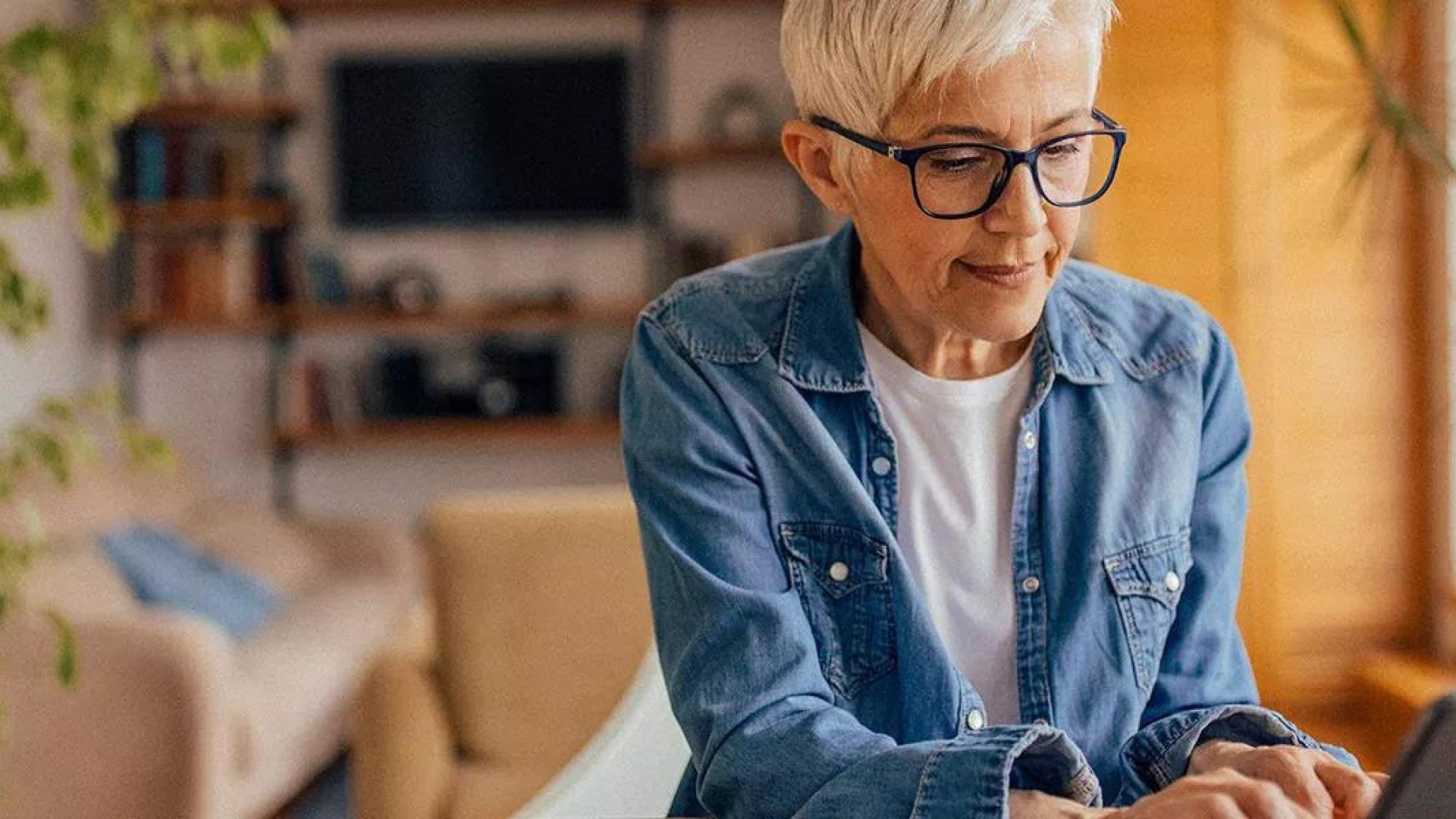 Image of retired woman reviewing her finances on a laptop