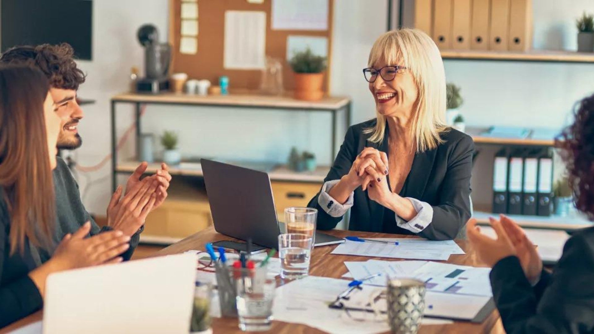 A group of employees discussing their preferences of benefits.