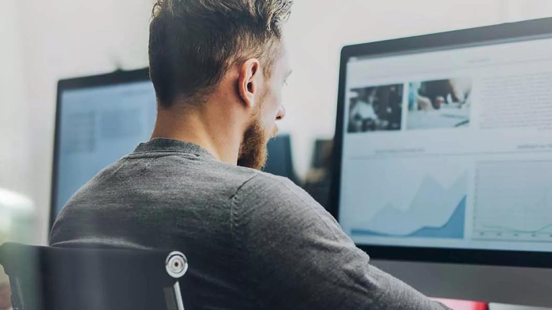 Photo of two employees working on their computers.