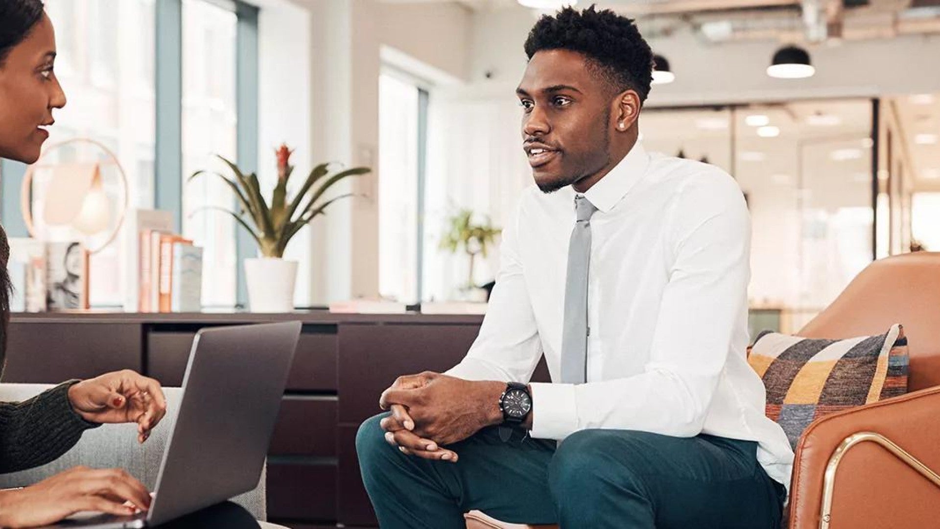 Photo of two people talking in an office.