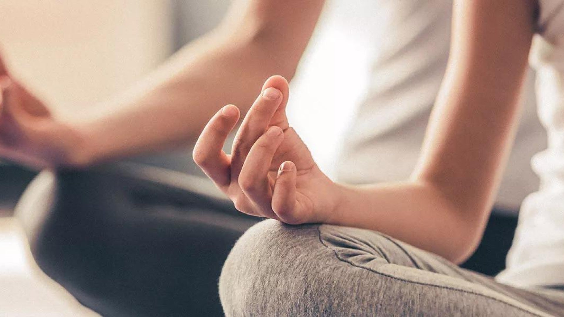Picture of two people doing yoga or meditating.