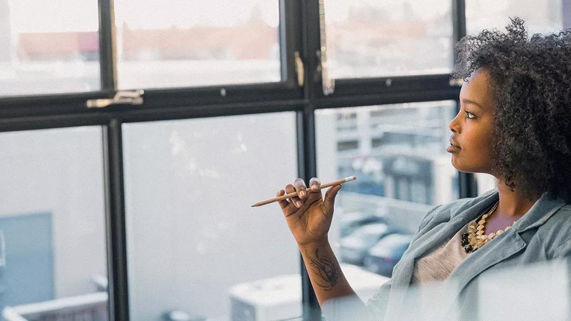 Image of of women sitting in an office, thinking about world events.