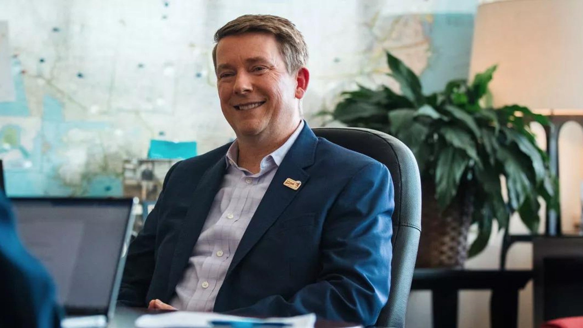 Businessman sits and discusses benefits with advisor.