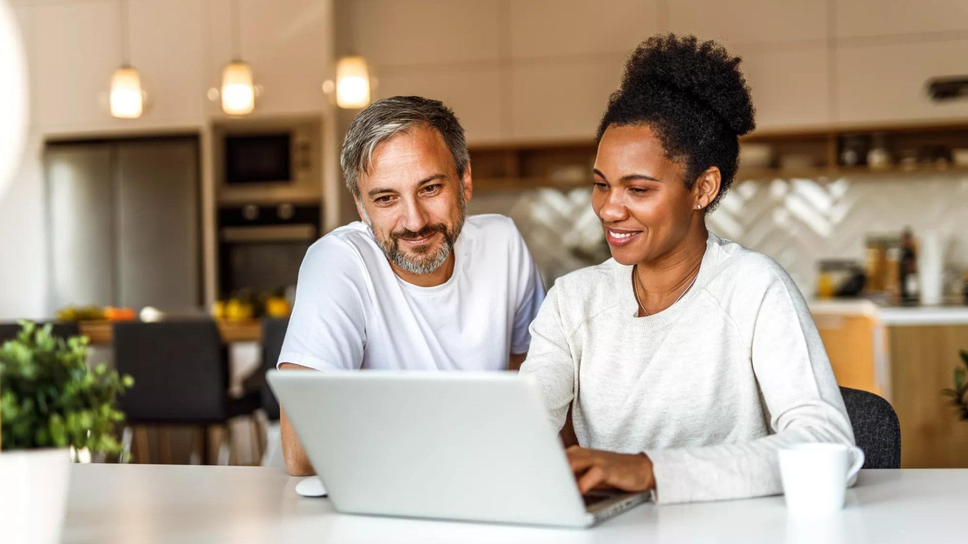 Couple sitting in kitchen working on updating a will.
