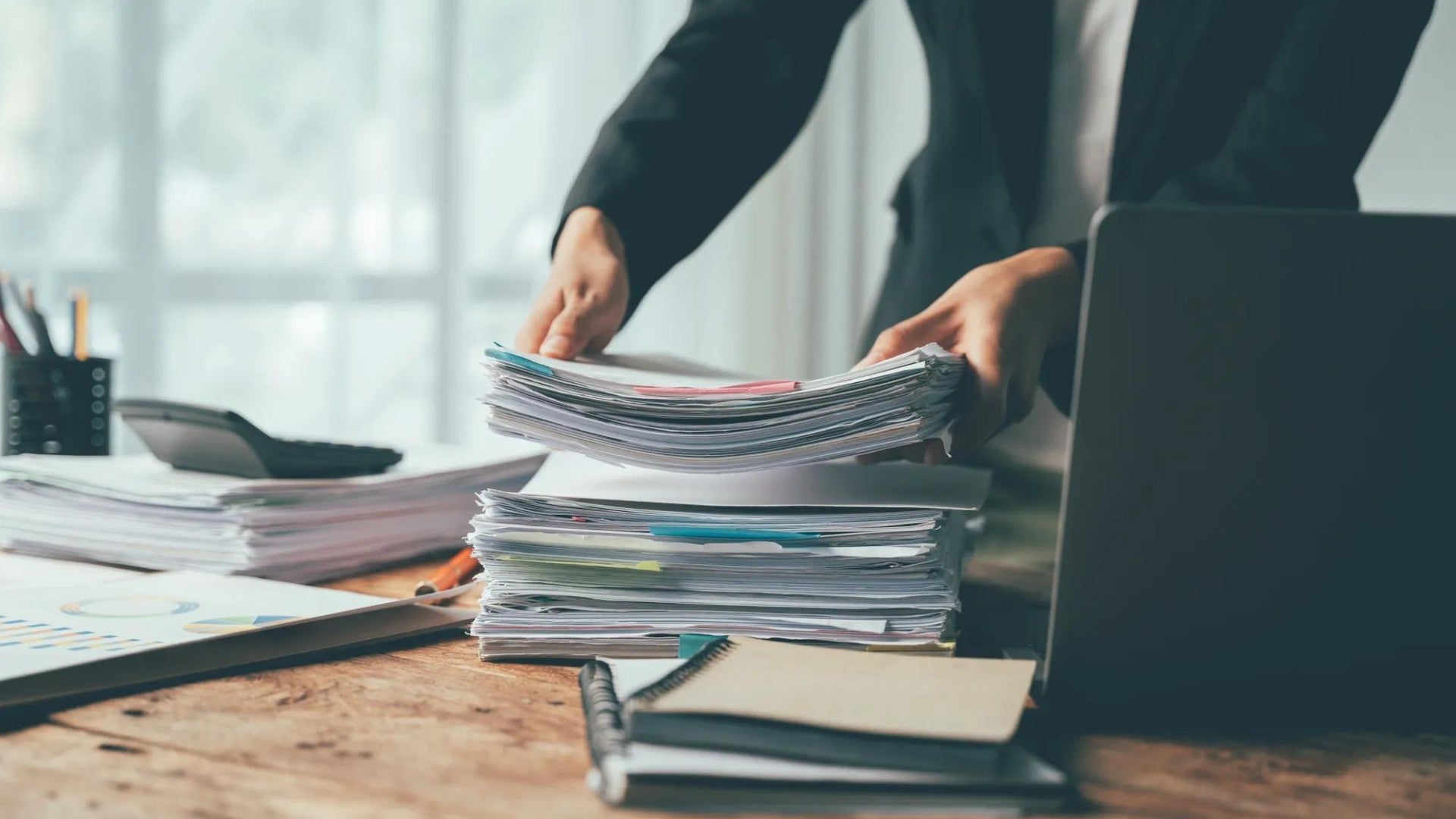 Stack of financial papers on a desk.