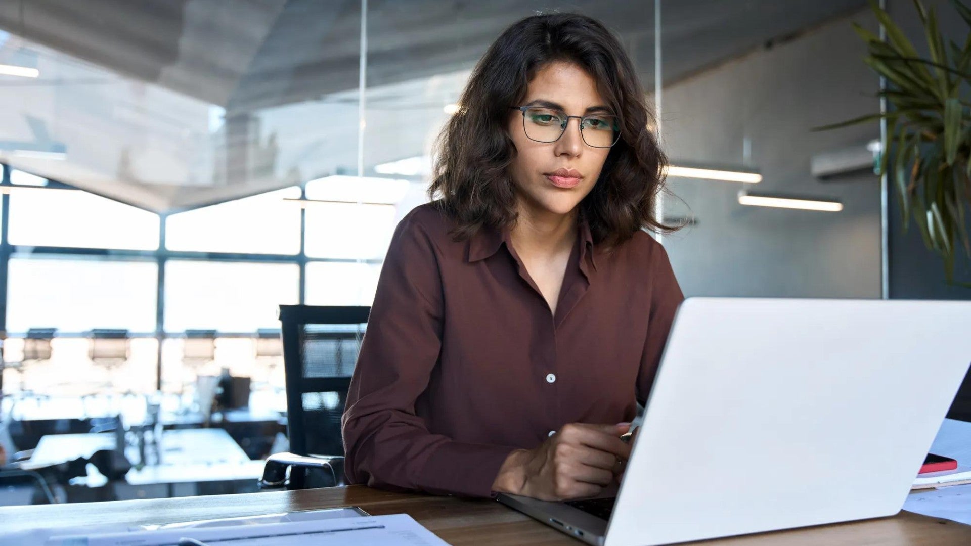 Woman using her laptop make purposeful financial decisions Woman using her laptop make purposeful financial decisions