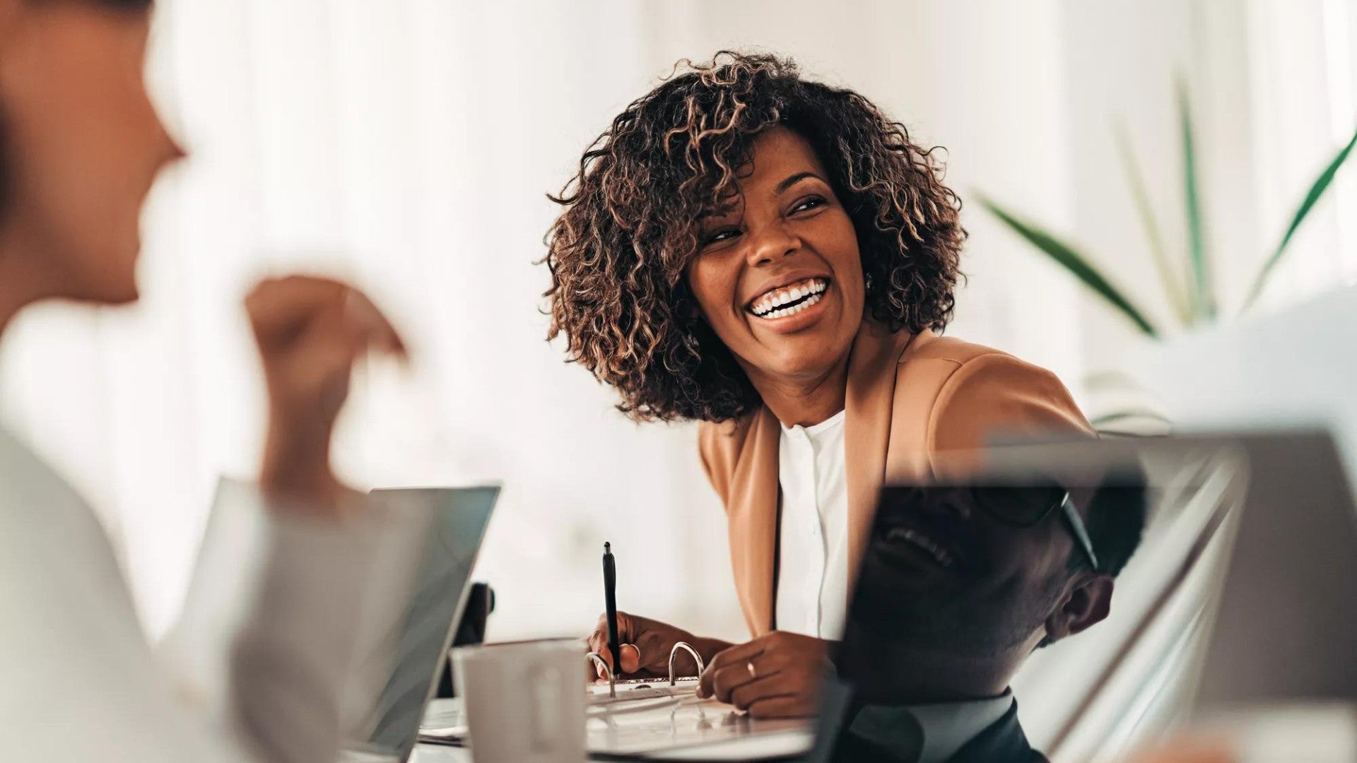 Portrait of cheerful businesswoman smiling at the meeting.