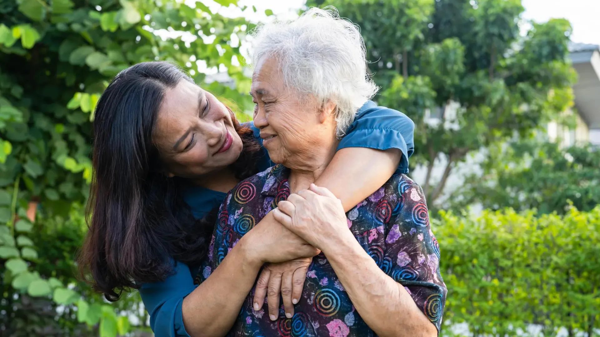 Older woman and middle age woman looking at each other.