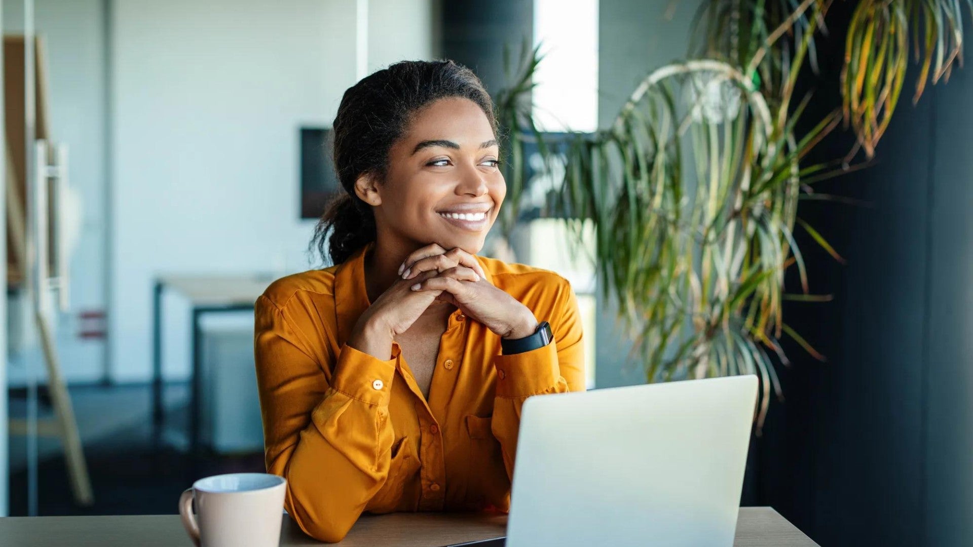 Woman at computer in quiet office environment.