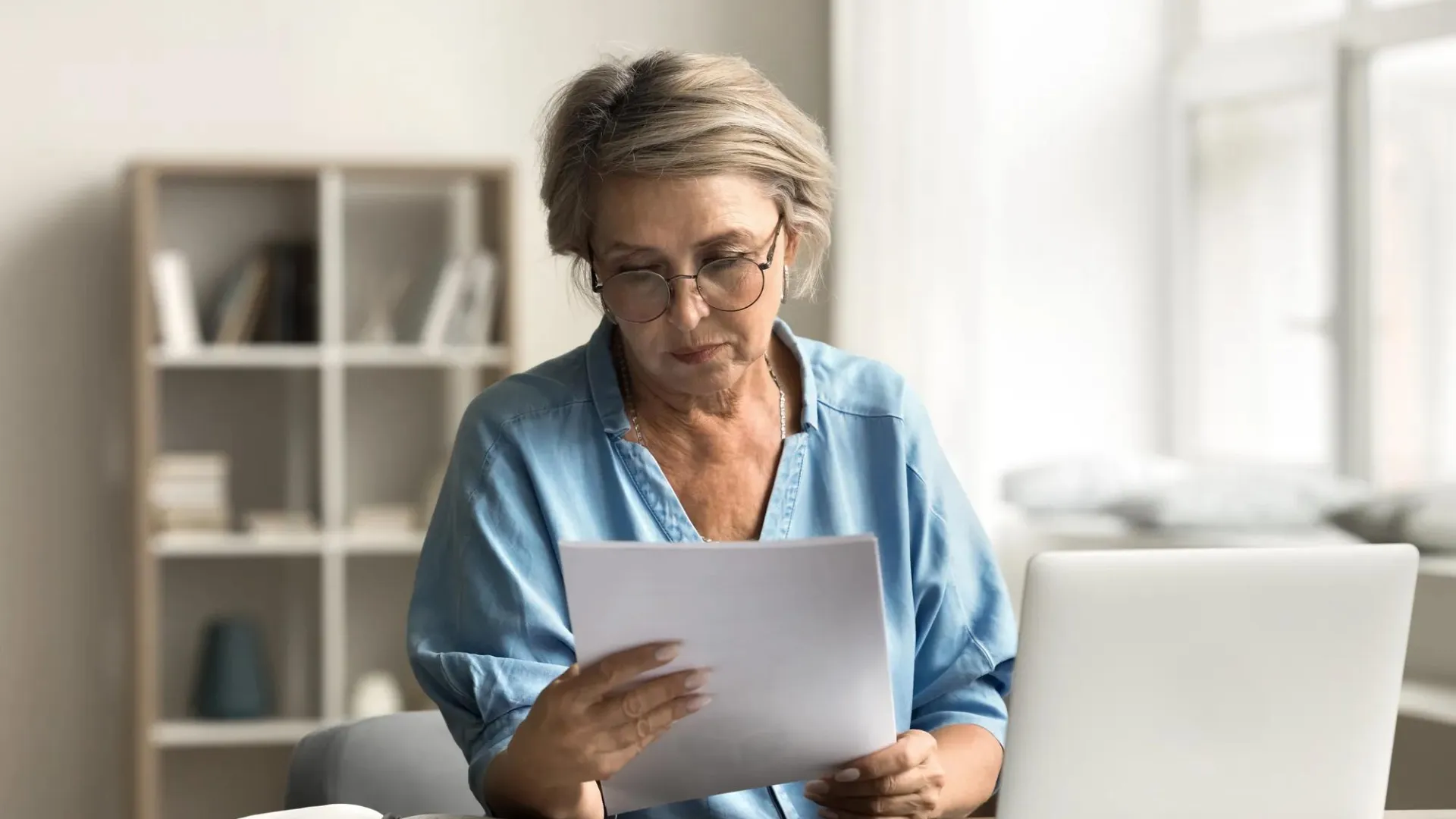 A woman reviewing her finances to consider debt consolidation