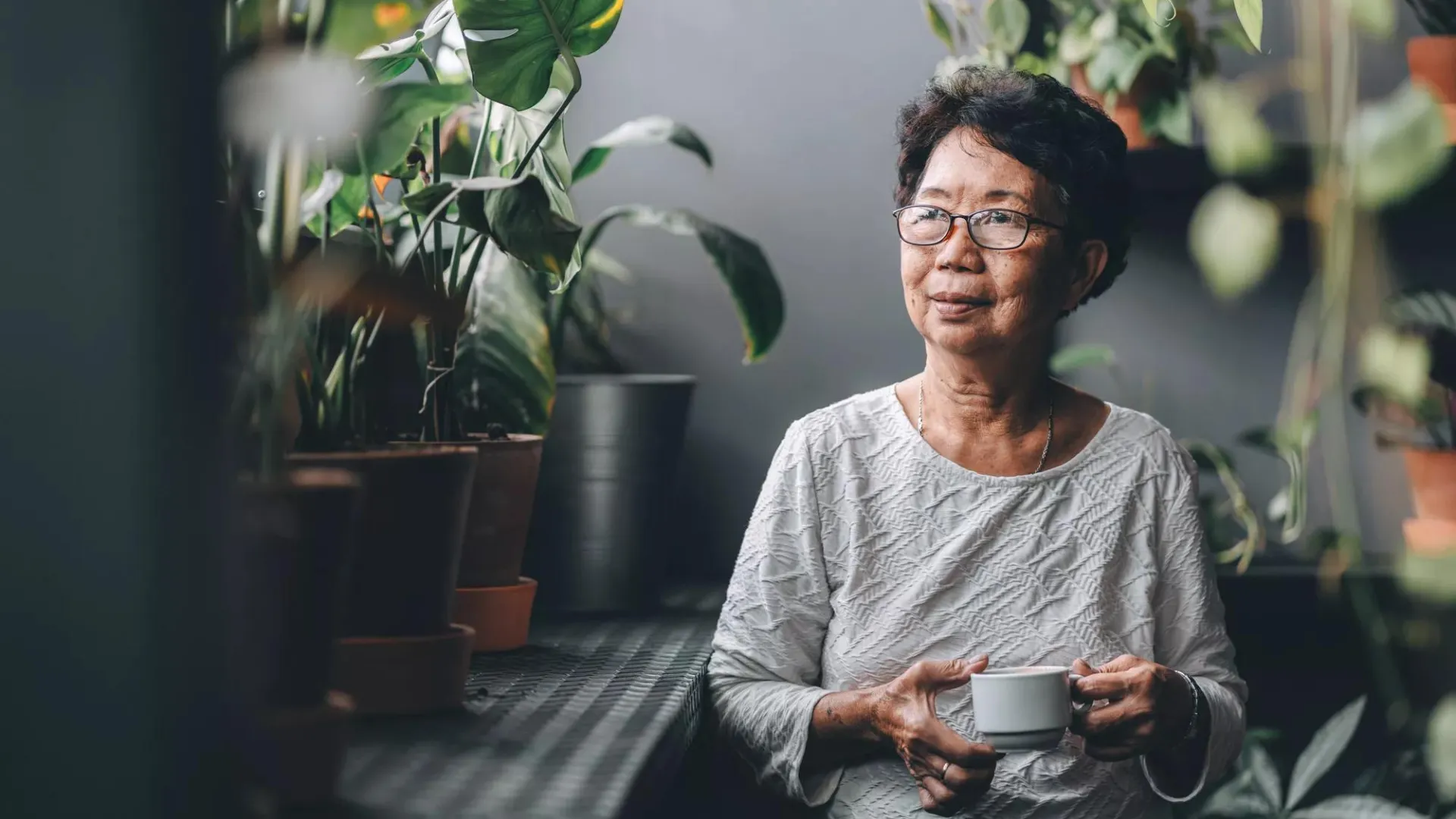 A woman sitting and drinking tea