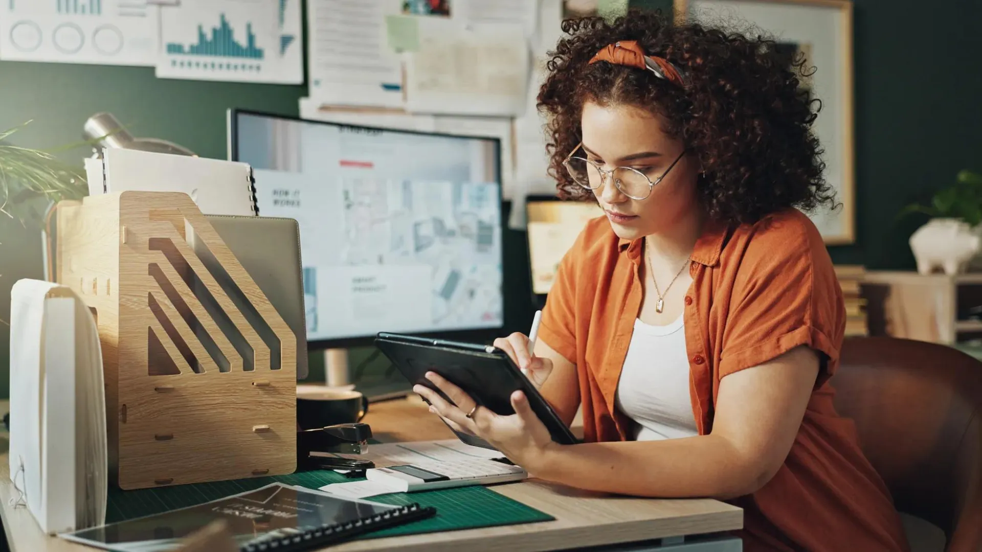 Woman working on tablet to review her finances