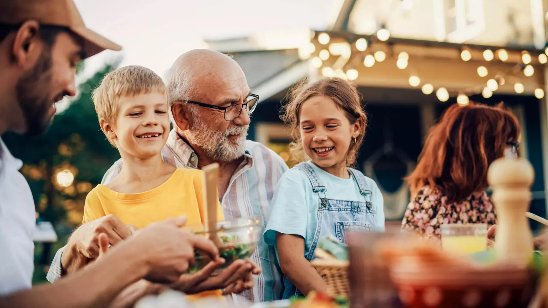 A grandfather enjoys dinner and spending time with his family