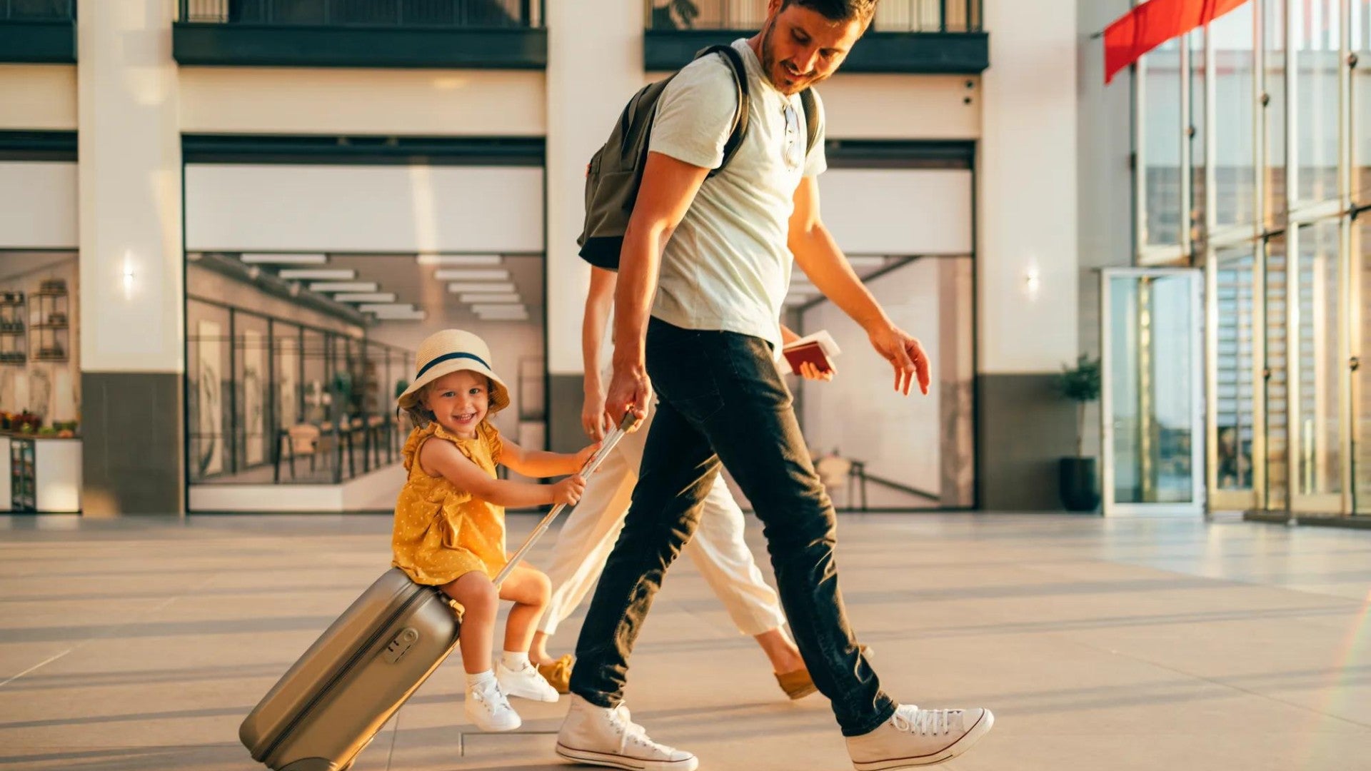 Family walking through the airport with their child.
