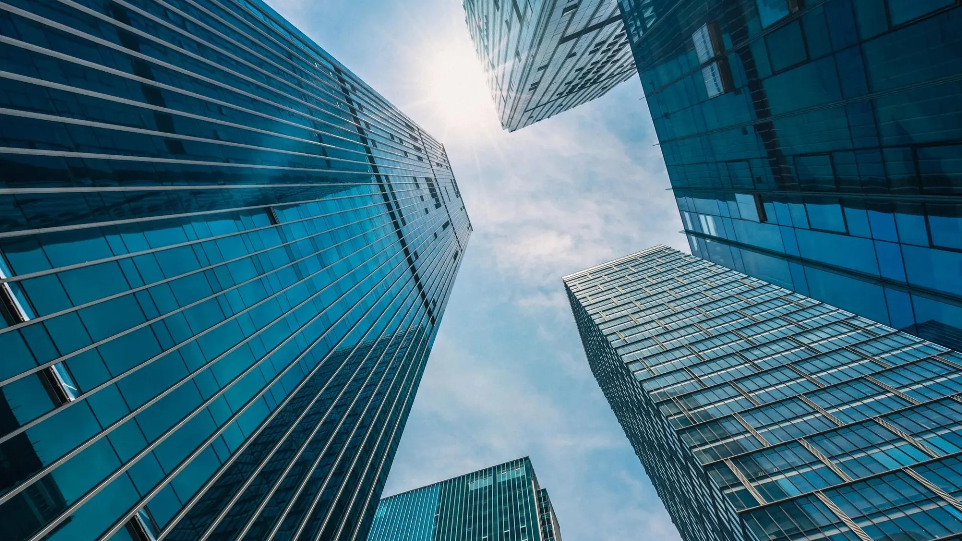 Looking up towards the top of several skyscrapers.