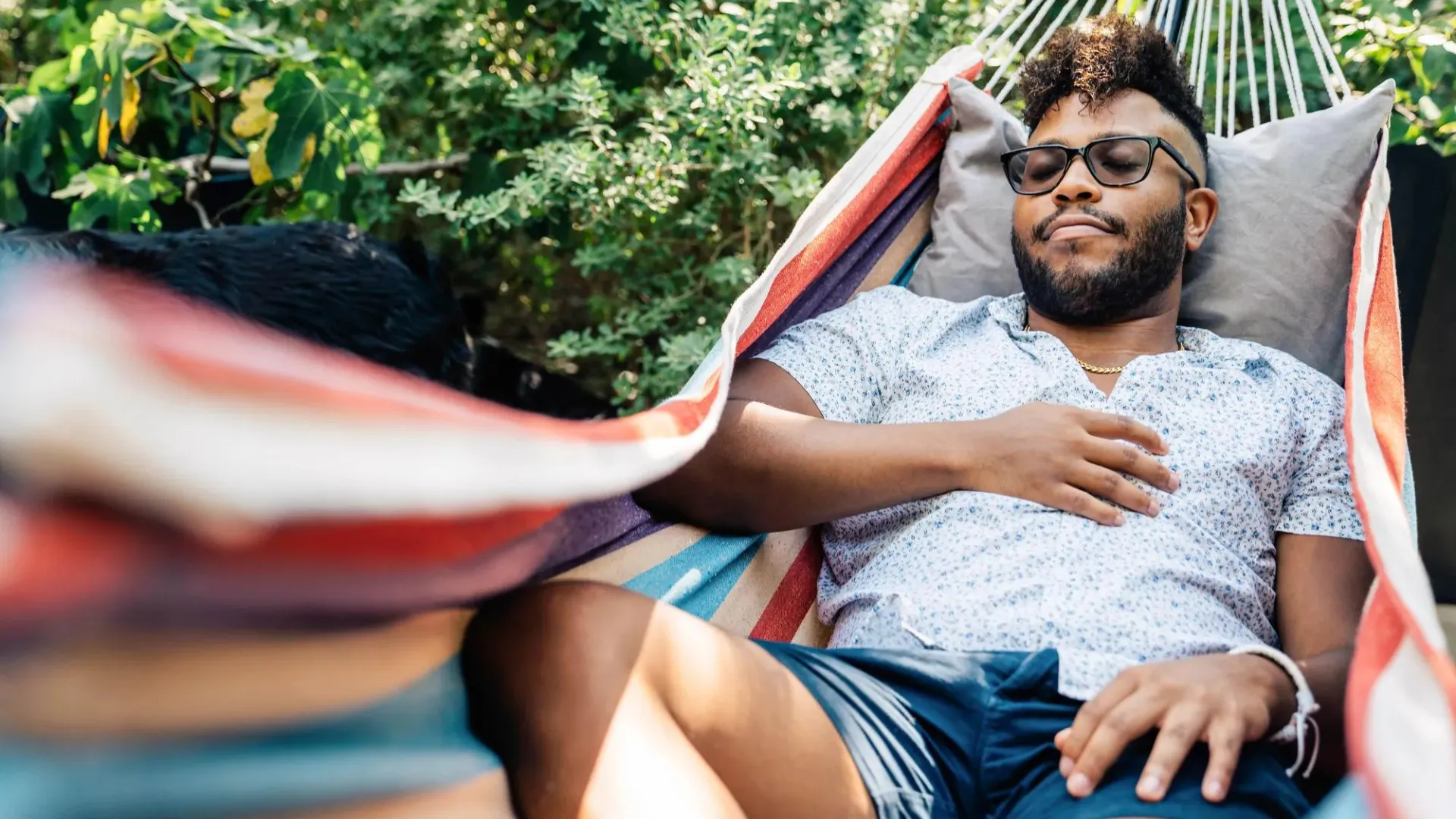 A man lounging in a hammock.