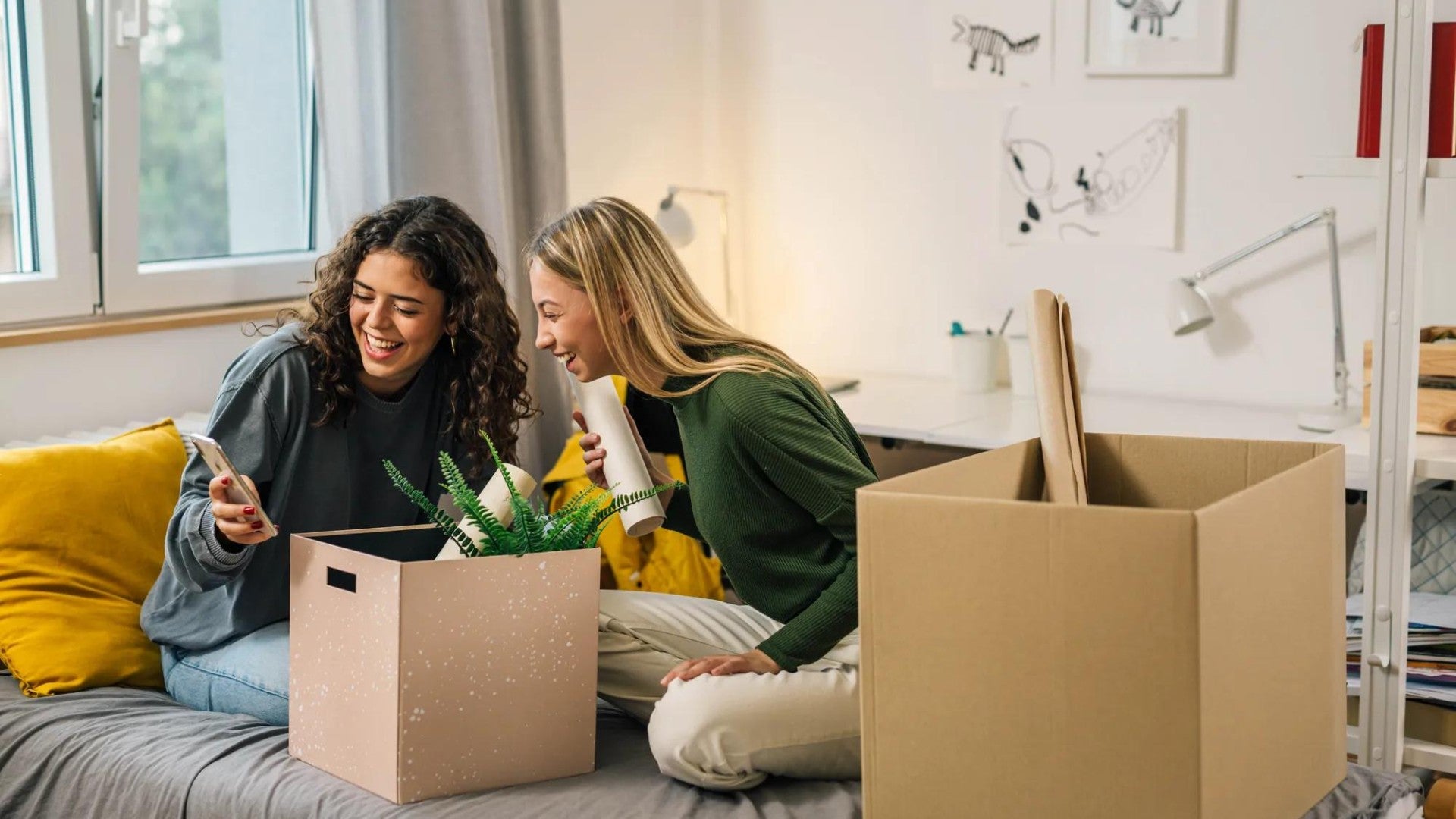 Two young adult women moving into dorm room