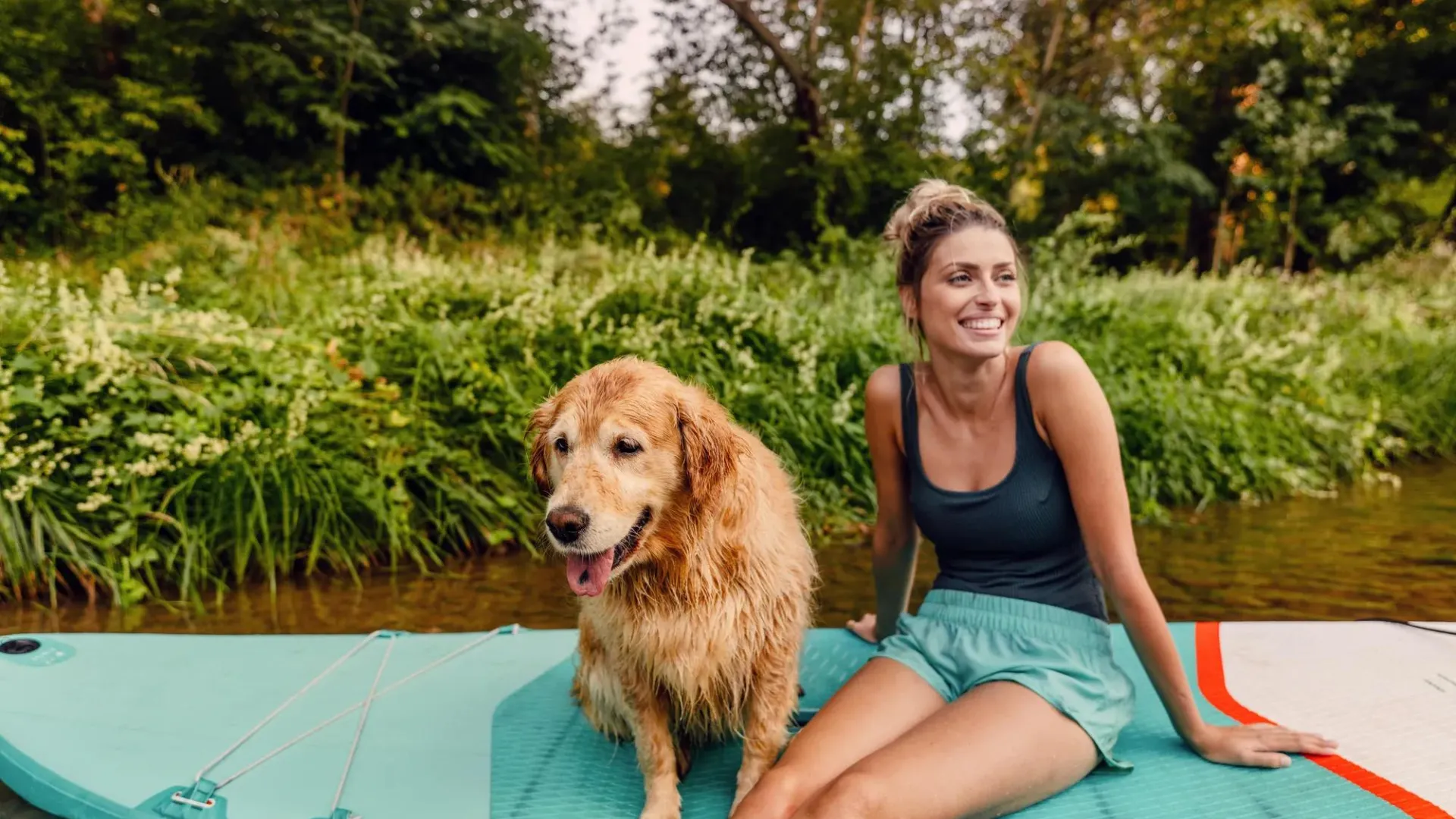 A woman sitting outside with her dog.