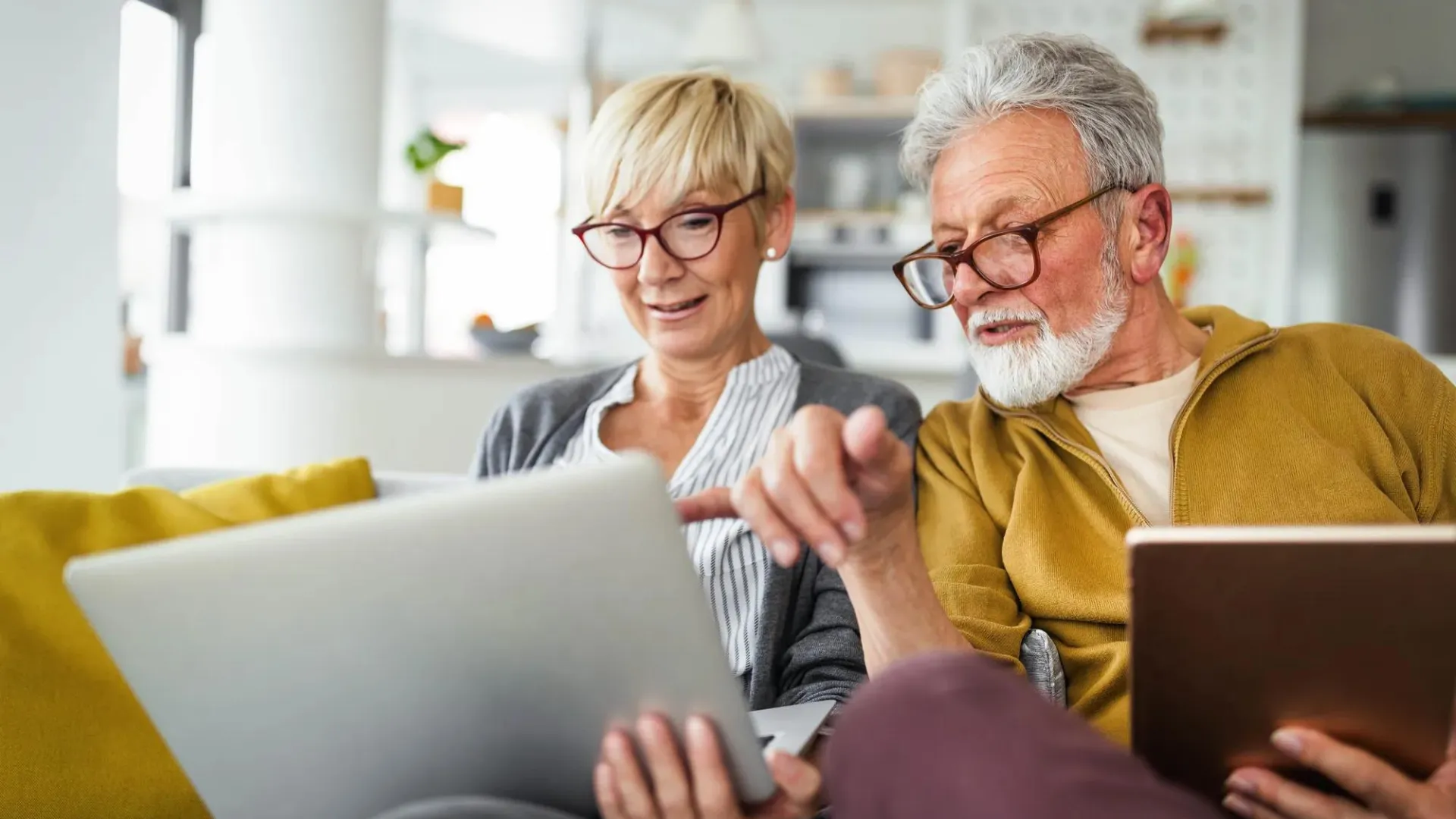Retired man and woman looking at a computer