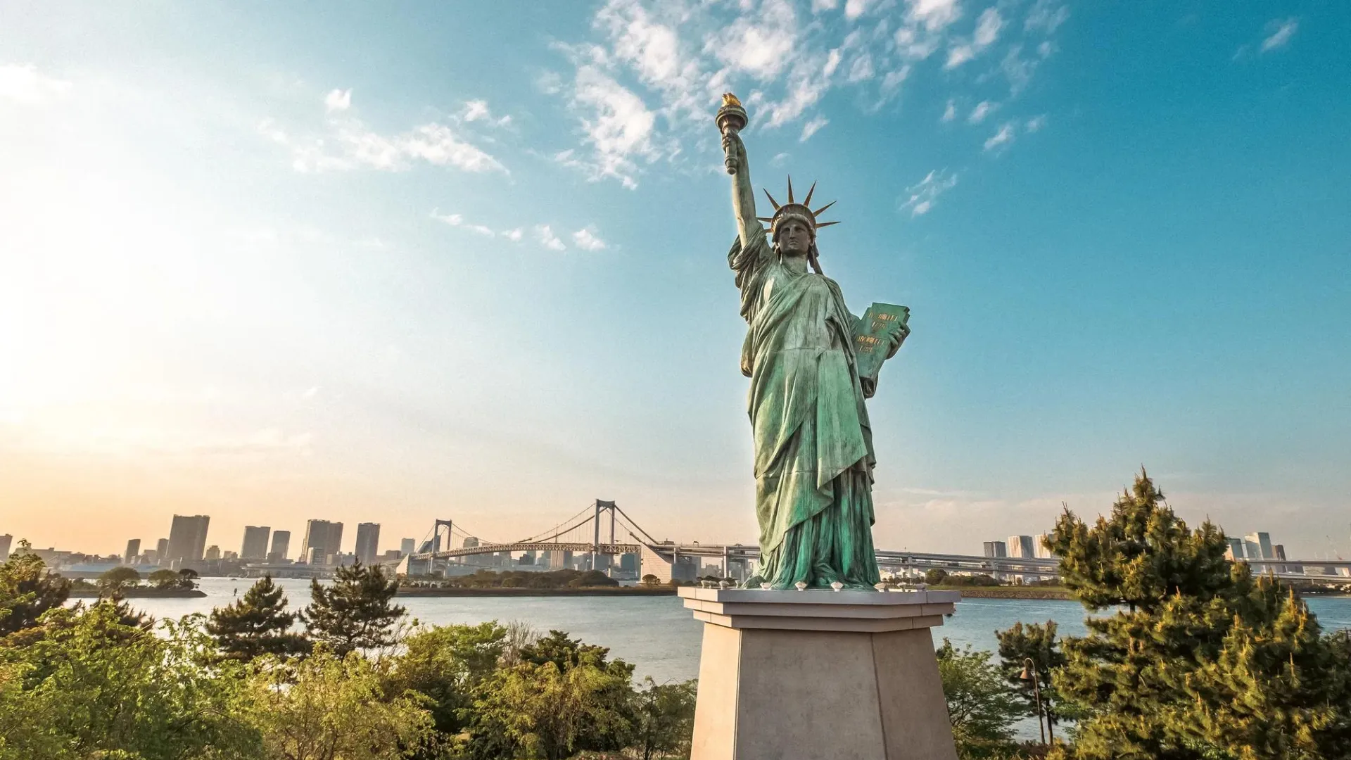 Statue of Liberty overlooking water and city skyline