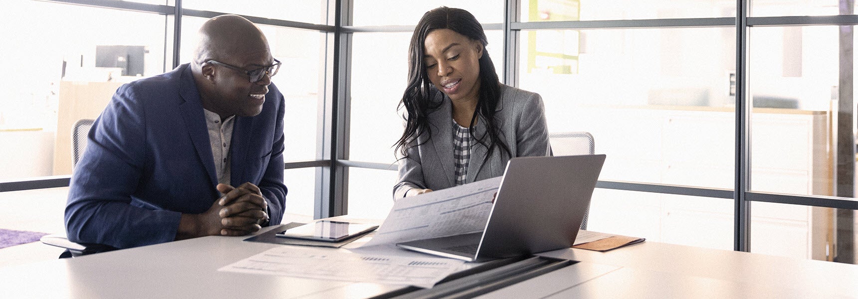 Photo of man reviewing his 2022 retirement contributions limits with his financial advisor.