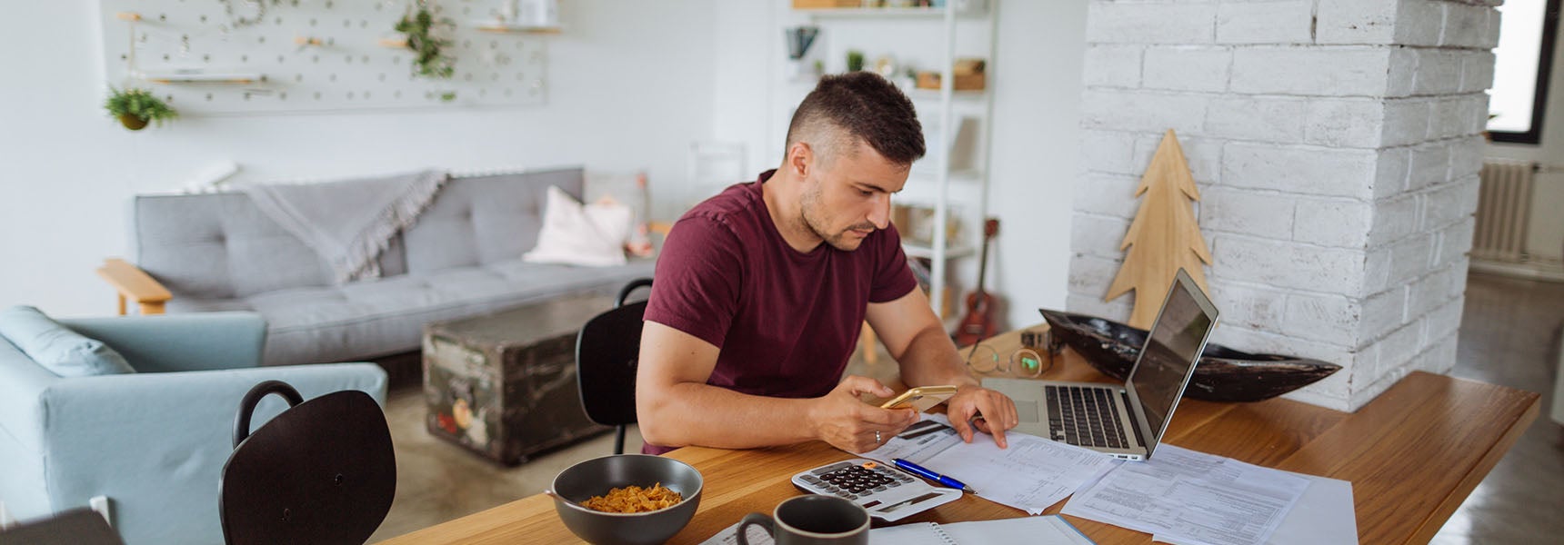 Photo of a man researching different methods to pay off debt..