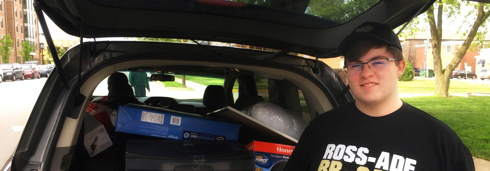 Photo of a boy moving into college.