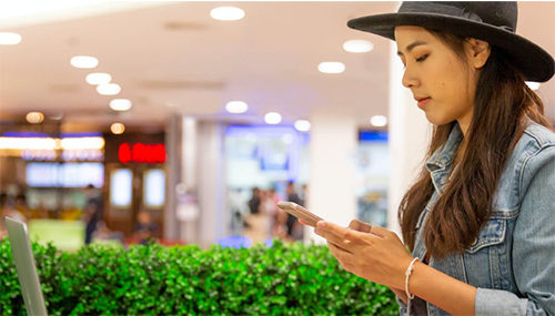 Picture of a woman on her phone. Photo of a woman on her phone.