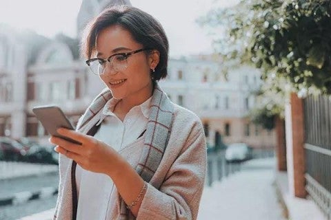 Woman reviewing her retirement plan on her cell phone