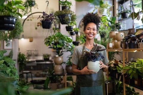 Photo of woman with plant in shop