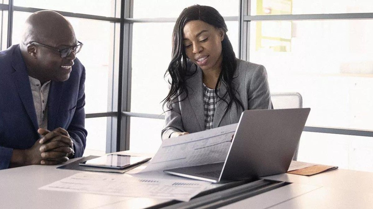 Photo of man reviewing his retirement contributions limits with their financial advisor. 