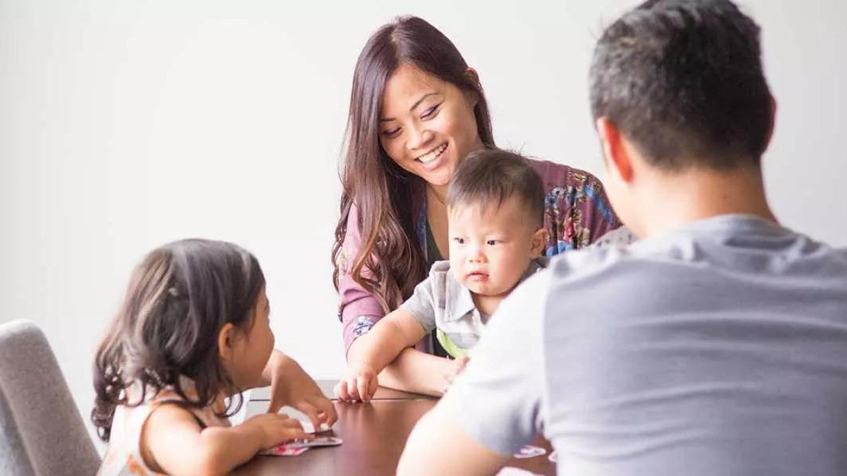 A family joyfully sitting at a table