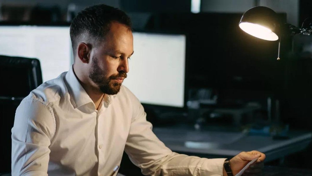 Man looking mildly stressed out at work.