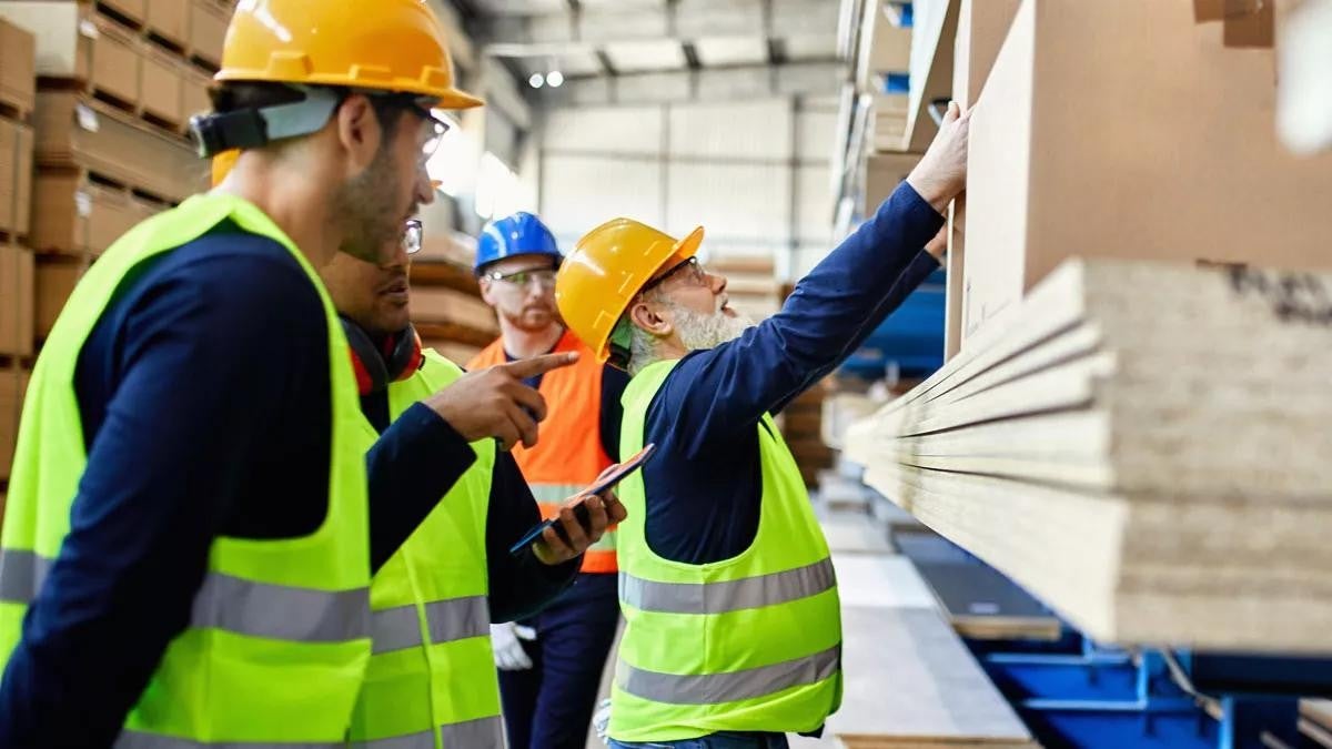 Men working in factory warehouse
